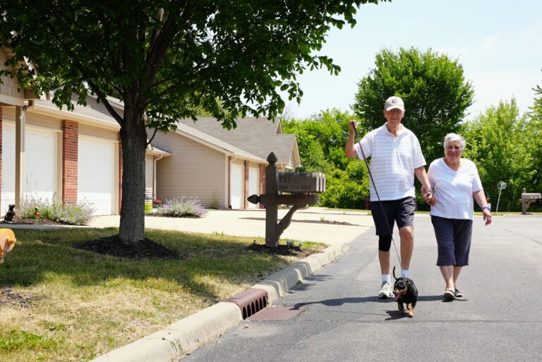 Male and female Garden Home residents walking their dog